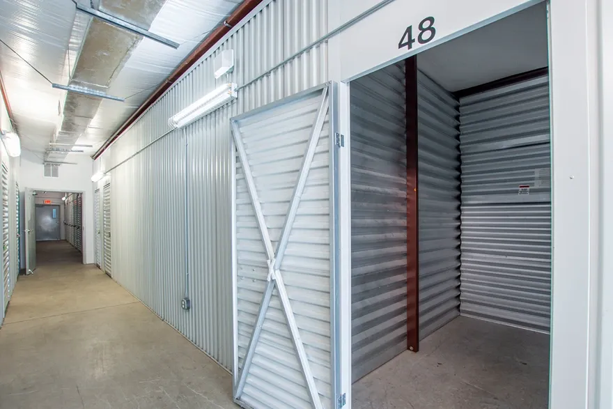 Indoor storage unit with roll-up door inside secure facility hallway